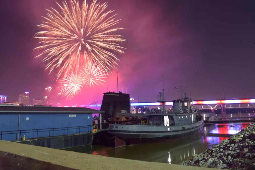 fireworks with USS Razorback submarine and USS Hoga in foreground