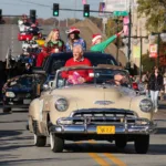 image of nlr mayor in car leading parade