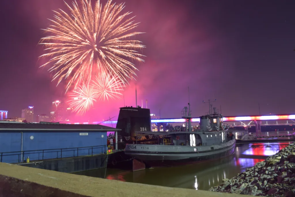 photo of fireworks with AIMM ships in foreground