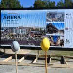 photo of rendering with shovels and hardhats in foreground