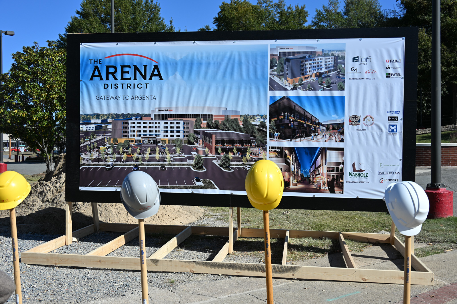 photo of rendering with shovels and hardhats in foreground